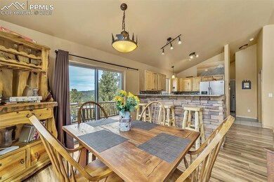 Dining area with light wood-style flooring and vau