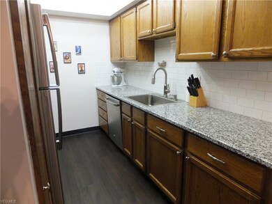 The galley kitchen offers maximum efficiency. Expansive granite-topped counters, all appliances stay.