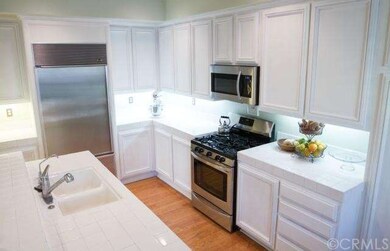 Open kitchen with customized white cabinets, incre
