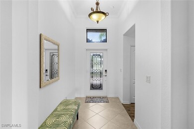 Tiled entrance foyer featuring ornamental molding