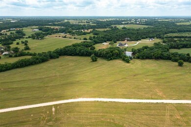 Birds eye view of property featuring a rural view