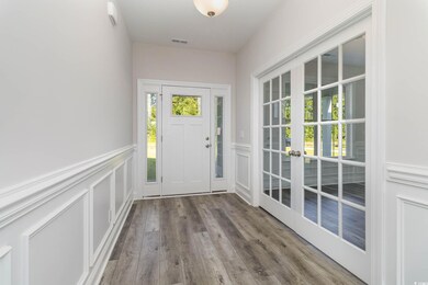 Doorway to outside with french doors and wood-type