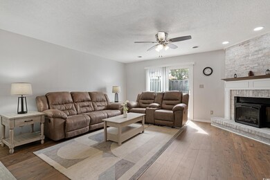 Living area featuring a textured ceiling, hardwood