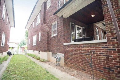 The side walkway leads to the fenced backyard.
