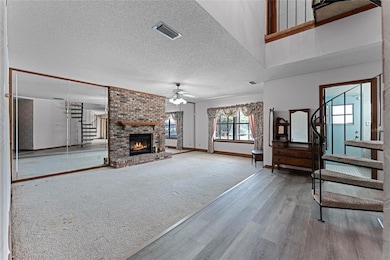 Huge 24x13 living room with fireplace! A spiral staircase takes you to the second-story primary suite.