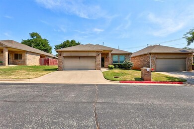 Ranch-style house featuring a front yard and a gar