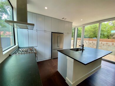Kitchen featuring freestanding refrigerator, a si