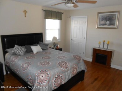 large master bedroom with wood floors