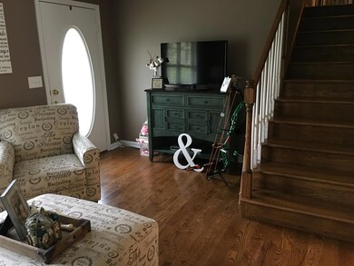 Living room has stunning new hardwood floor whihk also run up the stairs and in the upstairs hallway and bedrooms.
