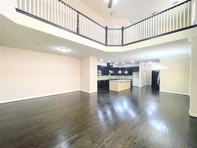 Unfurnished living room with a high ceiling and dark wood-type flooring