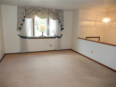 Spacious living room has neutral colors and plenty