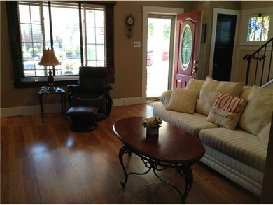 Living Room. LARGE TWO-INCH WOOD BLINDS ADD A WARM