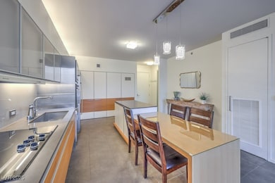 Kitchen featuring a sink, visible vents, black ele