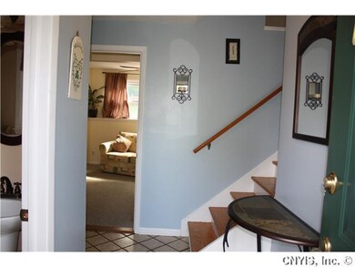 Foyer. Tile Foyer with Remodeled 1/2 Bath  leads i