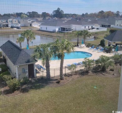 Community pool featuring a residential view, fence