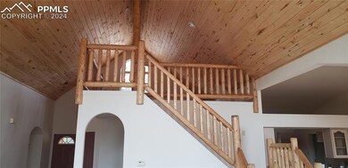 Stairway featuring high vaulted ceiling, beam ceil