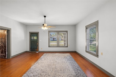 Foyer with wood finished floors and a ceiling fan