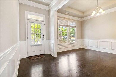Doorway to outside with visible vents, a wainscote