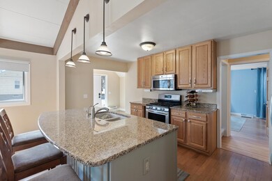 Nicely updated kitchen complete with granite countertops, stainless steel appliances, and large center island.