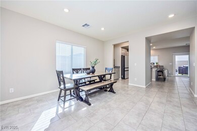 Dining space with recessed lighting and light tile patterned floors