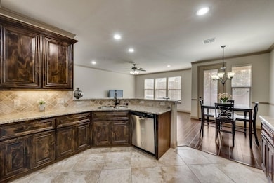 Kitchen featuring dark brown cabinets, crown molding, recessed lighting, pendant lighting, and backsplash