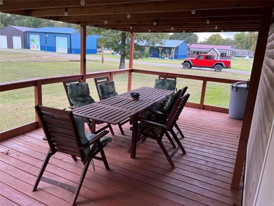 Deck with a lawn, an outbuilding, and a garage