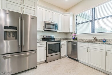Kitchen featuring stainless steel appliances, whit