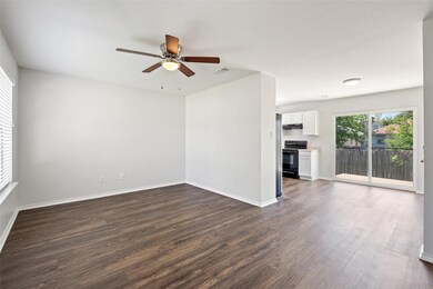 Unfurnished living room with ceiling fan, visible