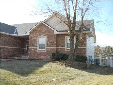 Side of home with fenced entry to back yard.