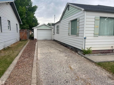 View of home's exterior with driveway, an outdoor structure, and a garage