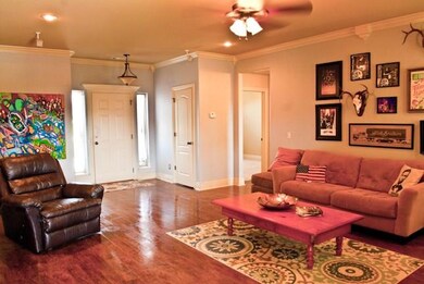This room is FULL of light. Note the gorgeous neutral wall color and crown moulding with accent pieces