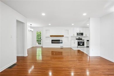 Unfurnished living room with a glass covered firep