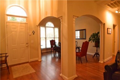 Dining room . . . beautiful hardwood floors . . . lots of light . . . columns . . . easy entertaining
