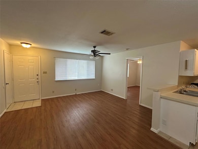 Unfurnished living room featuring wood finished f