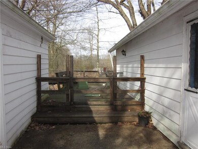 Deck in between house and detached garage.