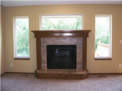 The gas fireplace is flanked by three Low E window