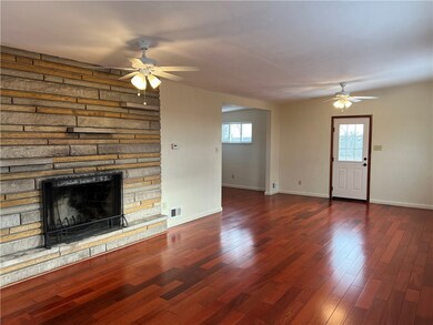 Living Room with Wood Burner and Gleaming Hardwood