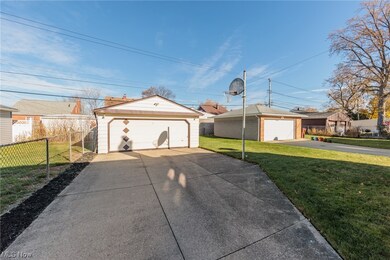 Ranch-style house featuring a garage and a front yard