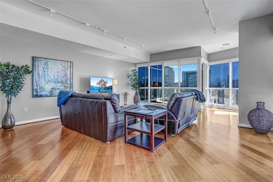 Living area with track lighting and wood finished floors