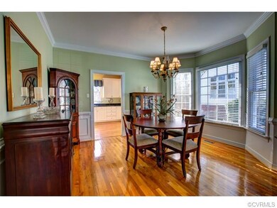Dining Room with wood flooring. Bay window-Open to
