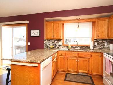 Kitchen features Granite counters, tile backsplash