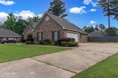 View of property with a garage and a front yard
