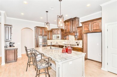 The over-sized island features an exotic granite, 