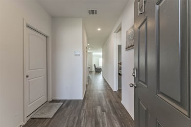 Luxury vinyl plank floors and a wide hallway welcome you inside.