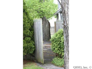 Exterior Front open gate leading to back yard