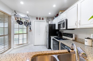 Kitchen with light stone countertops, stainless st