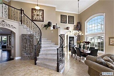 Gorgeous Foyer is very inviting with wrought iron 