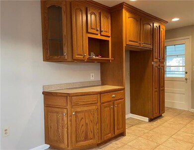 Additional kitchen space with wood cabinetry and a
