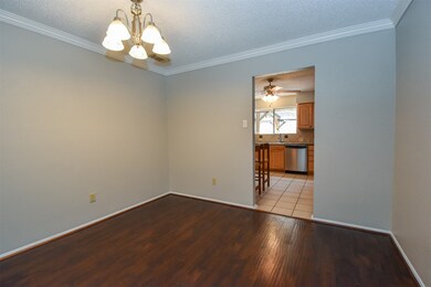 Gracious dining room with the same rich wood floor