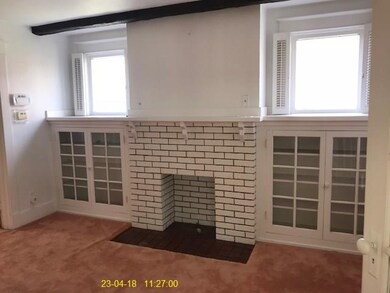 livingroom with decorative fireplace and builtin s